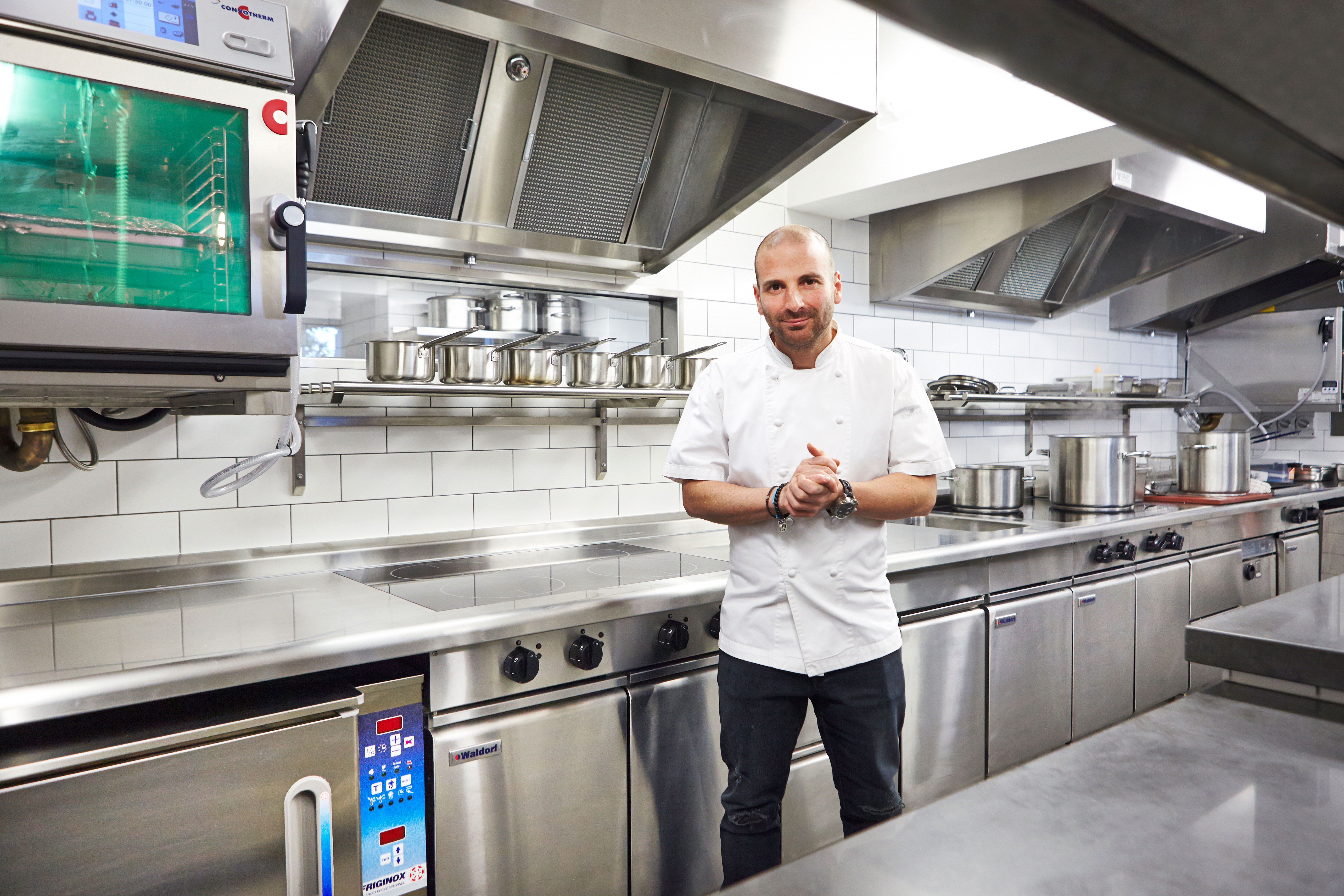 The equipment range includes two Waldorf Bold 4-zone induction cooktops and a Waldorf twin pan commercial deep fryer.